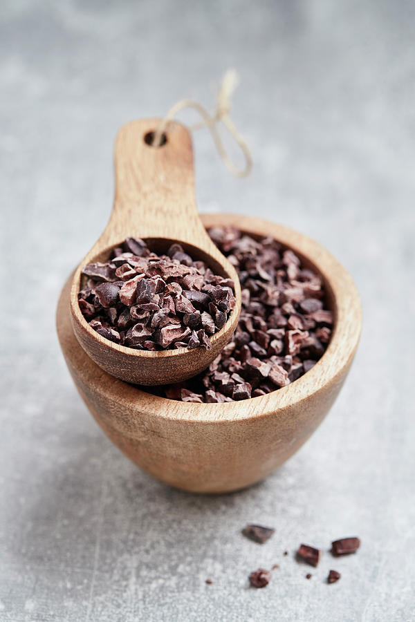 Cocoa Nibs In A Wooden Bowl And A Wooden Scoop Photograph by Brigitte Sporrer