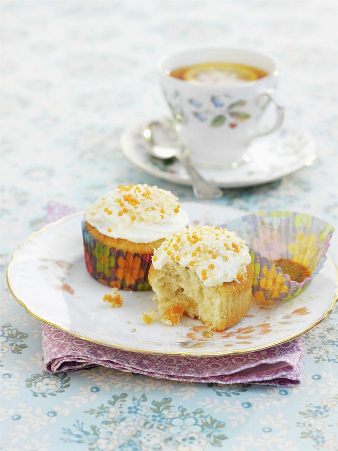 Coconut And Apricot Cupcakes And Lemon Tea Photograph by Garlick, Ian