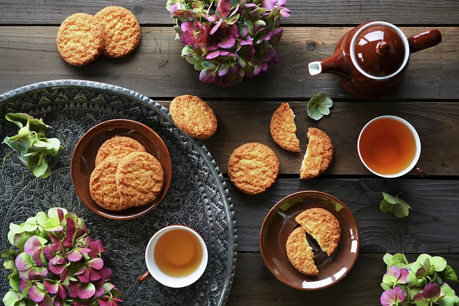 Coconut Biscuits And Tea On A Tray, Decorated With Fresh Flowers Photograph by Mariola Streim