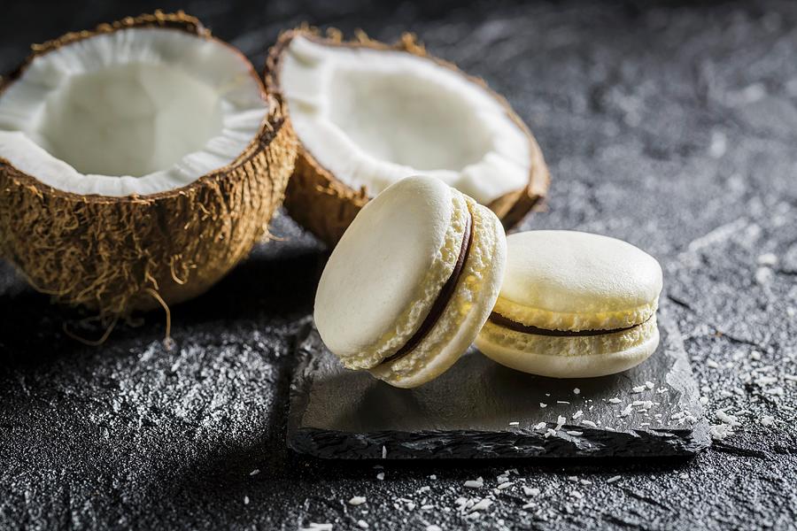 Coconut Macarons On A Black Stone Photograph by Shaiith