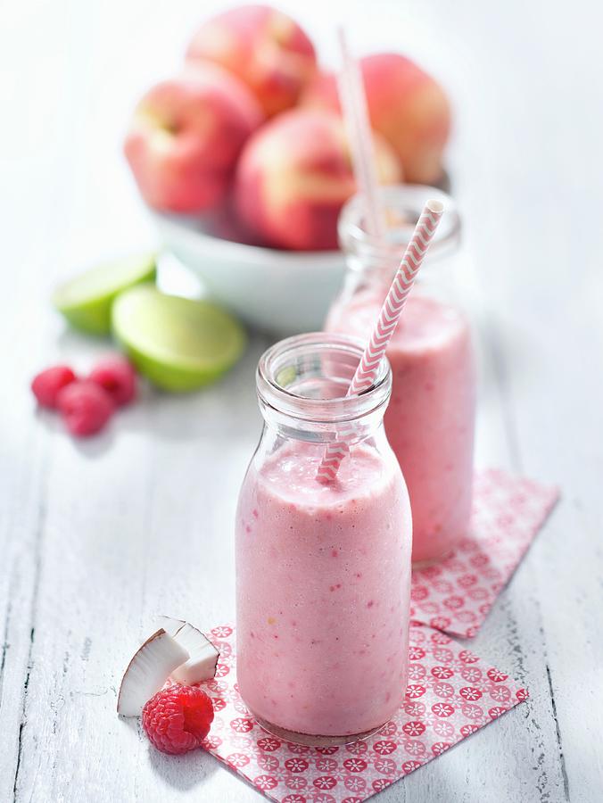 Coconut Milk, Peach, Lime And Raspberry Sorbet Smoothie Photograph by Studio