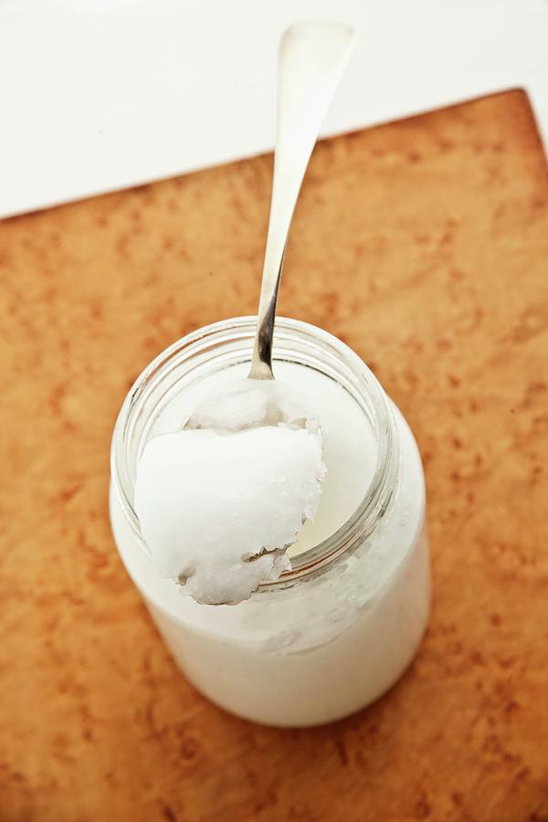 Coconut Oil In A Jar And On A Spoon Photograph by William Boch