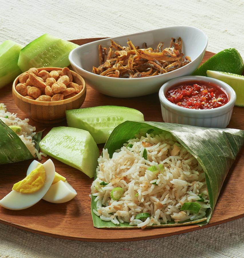 Coconut Rice In A Banana Leaf, Eggs, Fish, Cucumber And A Dip asia Photograph by Jim Scherer