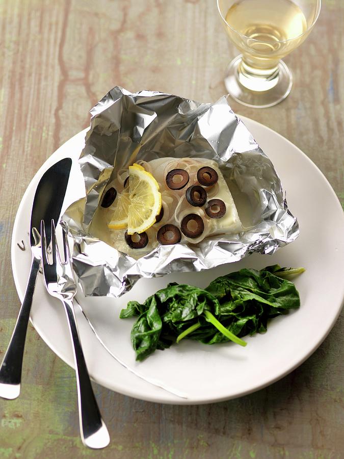 Cod, Lemon And Olives Cooked In Aluminium Foil Photograph by Gelberger