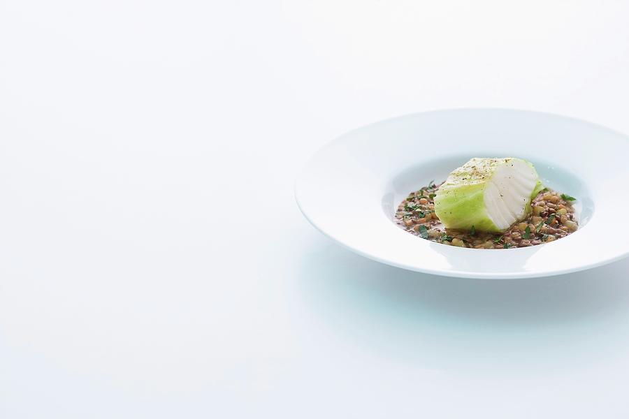 Cod Wrapped In Point Of Cabbage On A Bed Of Lentils Photograph by Michael Wissing