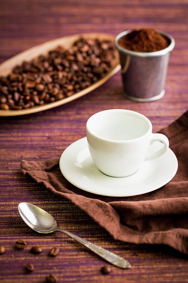 Coffee Beans, Coffee Powder, A Coffee Cup And A Coffee Spoon Photograph by Sandra Krimshandl-tauscher