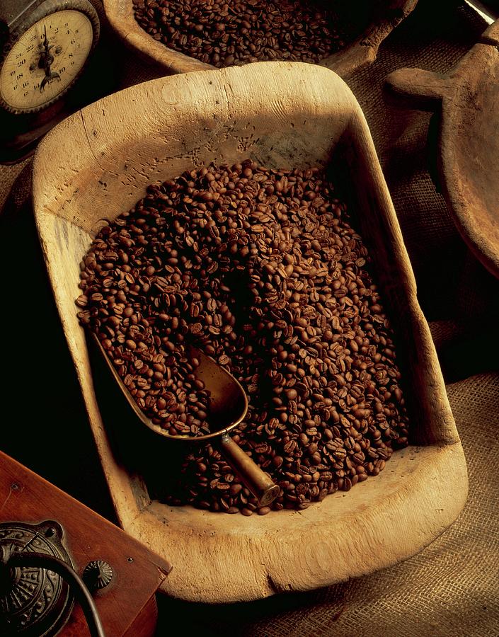 Coffee Beans In A Wooden Bowl With A Scoop, An Old Coffee Grinder And A Pair Of Kitchen Scales Photograph by Paul Poplis