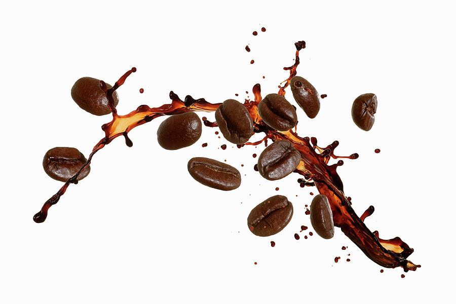 Coffee Beans With A Splash Of Coffee Photograph by Krger & Gross