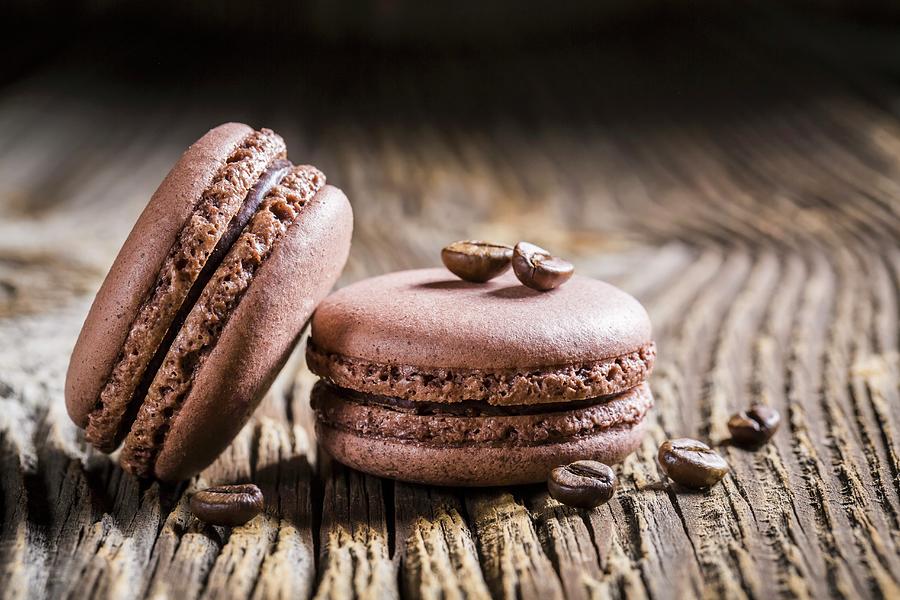 Coffee Macaroons On A Wooden Table Photograph by Shaiith