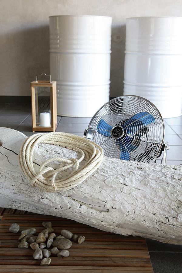 Coiled Rope On Whitewashed Tree Trunk On Floor In Front Of Fan With White-painted Metal Drums In Background Photograph by Michal Mrowiec
