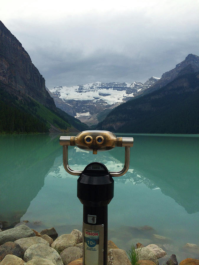 Mountain Photograph - Coin-operated Binoculars Against Lake Under Overcast Sky by Cavan Images