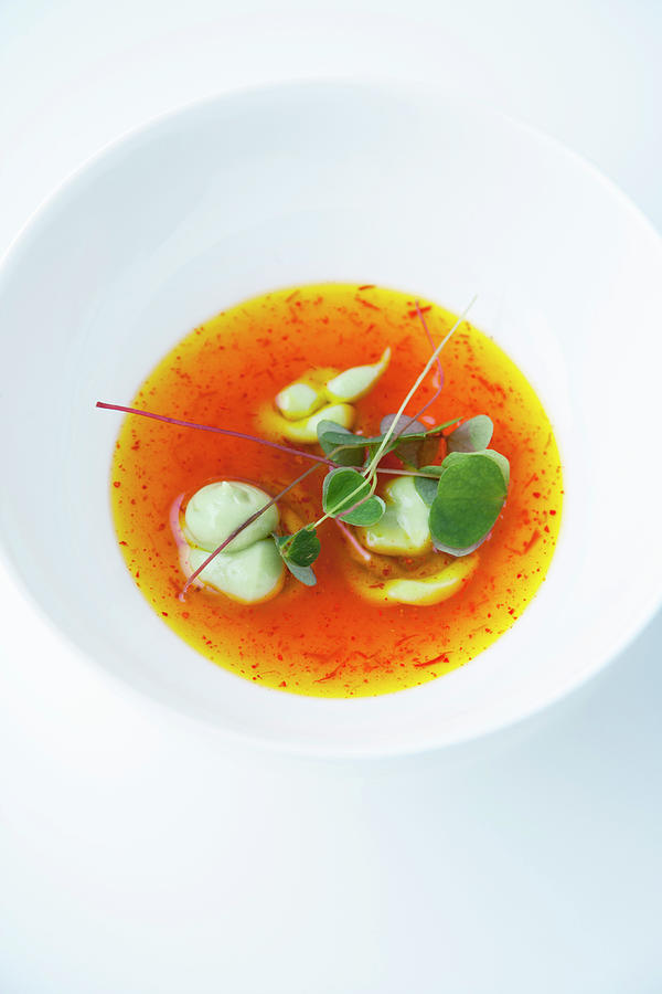 Cold Saffron Essence With Avocado Cream And Wood Sorrel Photograph by Michael Wissing