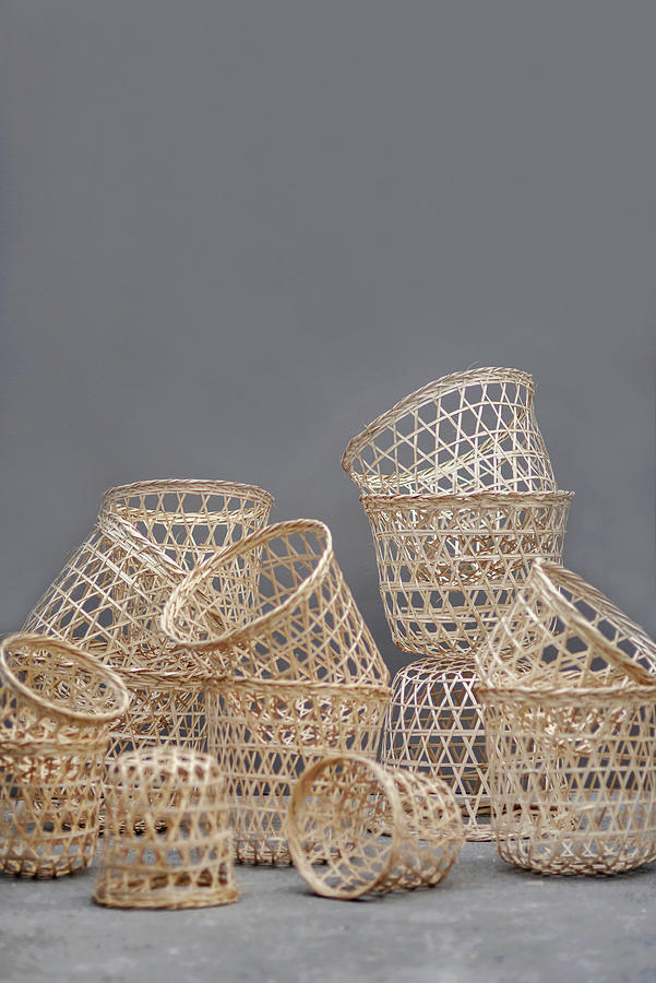 Collection Of Baskets Of Various Sizes Against Grey Wall Photograph by Magdalena Bjrnsdotter