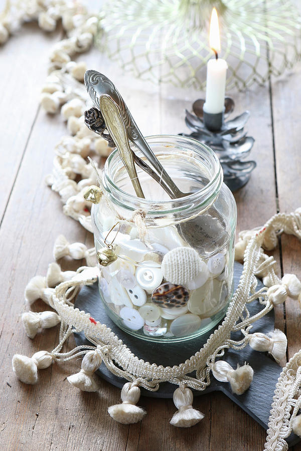 Collection Of Buttons And Antique Spoons In Jar Surrounded By Tasselled Trim Photograph by Regina Hippel