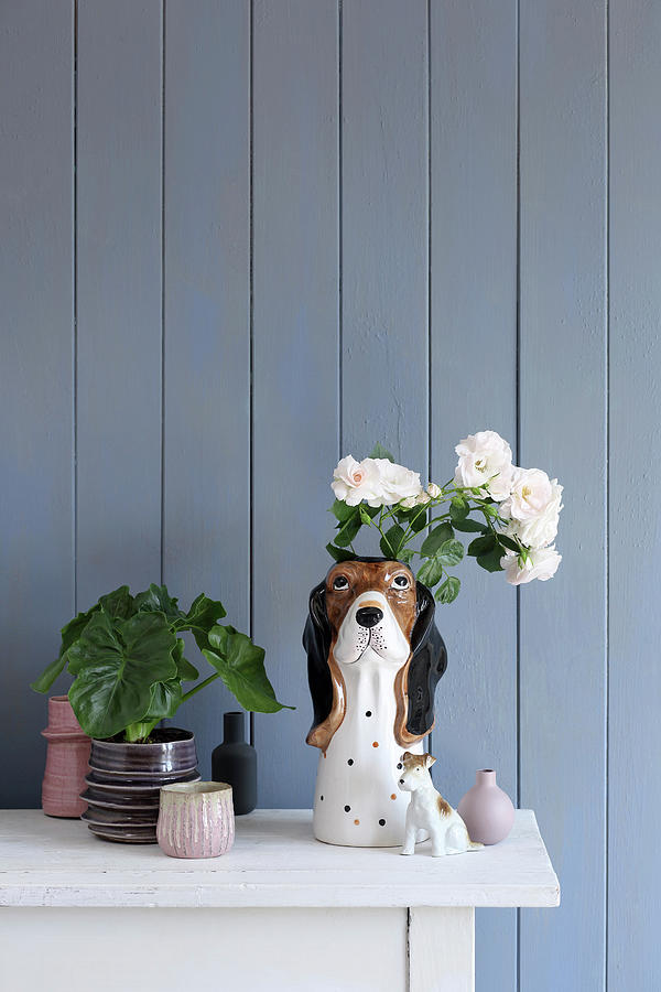 Collection Of Vases And Dog Figurines Against Blue-grey Board Wall Photograph by Thordis Rggeberg
