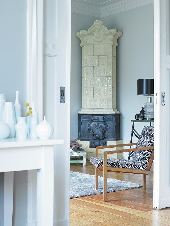 Collection Of Vases On Console Table In Anteroom Next To Open Sliding Door; Armchair And Tiled Stove In Corner Of Room Beyond Photograph by Stefan Thurmann