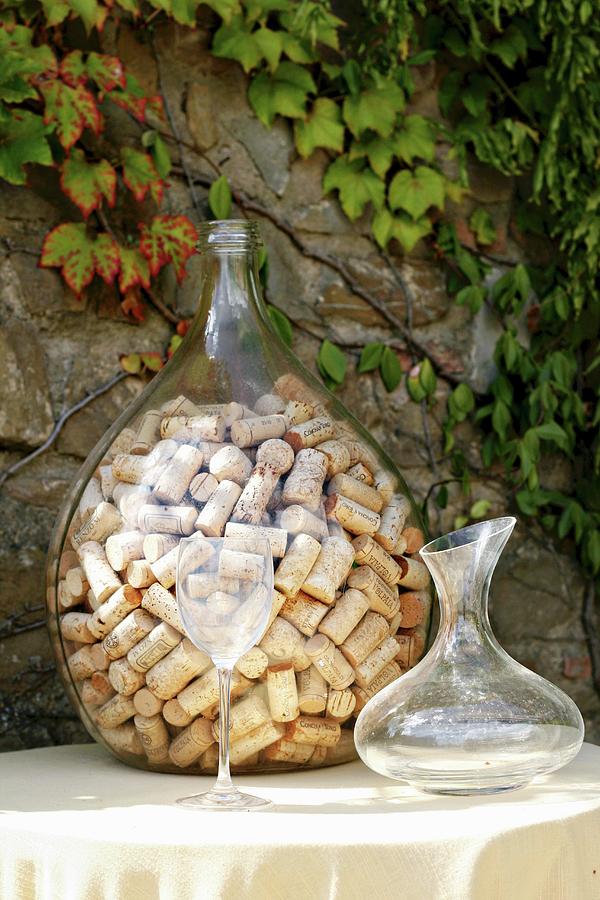 Collection Of Wine Bottle Corks In Demijohn Photograph by Alexandra Panella