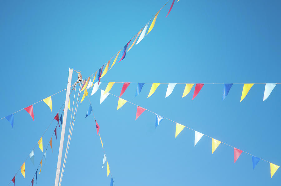 Colorful Flags Above Blue Sky Photograph by Marta Nardini