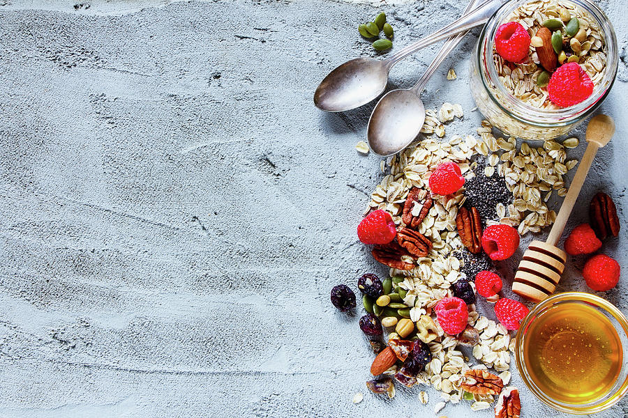 Colorful Ingredients For Cooking Breakfast Or Smoothie fresh Berries, Nuts, Oat Flakes, Dried Fruits, Chia Seeds And Honey Over Concrete Textured Background Photograph by Yuliya Gontar