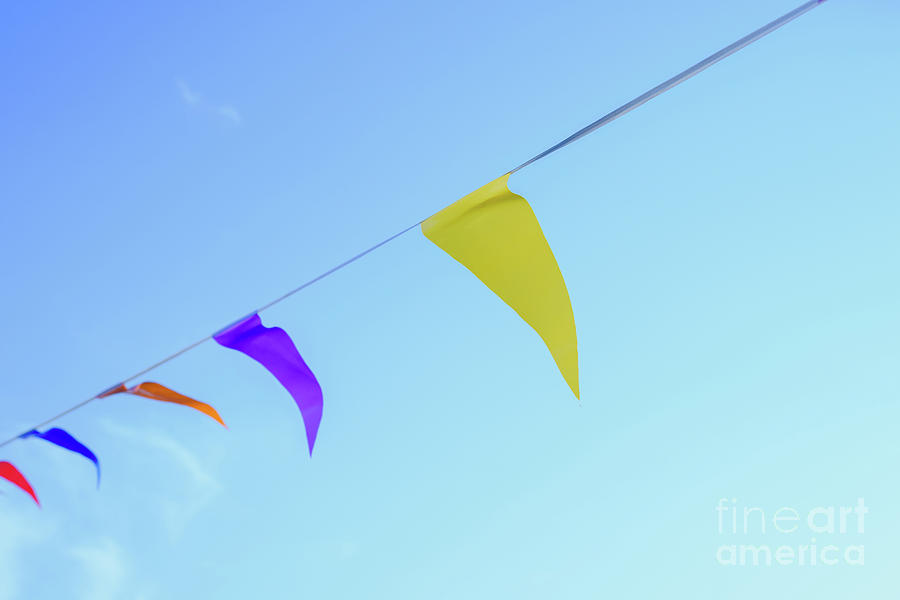 Colorful pennants with sky background to place text Photograph by Joaquin Corbalan
