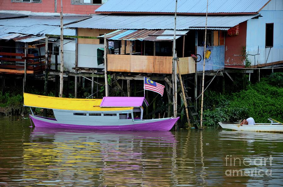 Colorful purple  and yellow boat on Sarawak River by kampong village Kuching Malaysia Photograph by Imran Ahmed