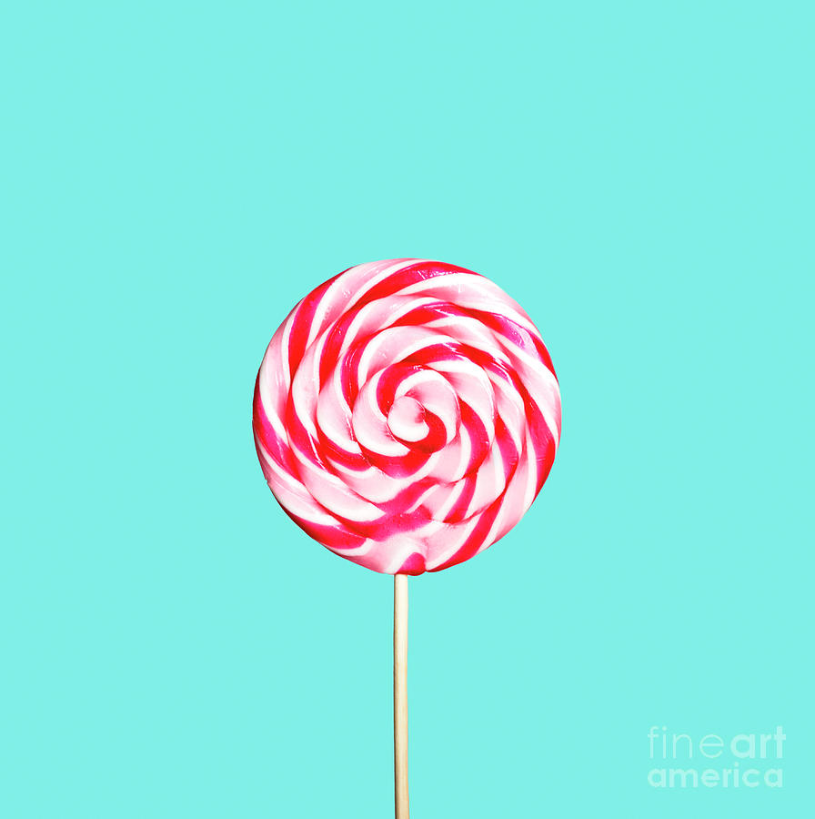Colorful red and pink lollipop on pastel blue background. Photograph by Jelena Jovanovic