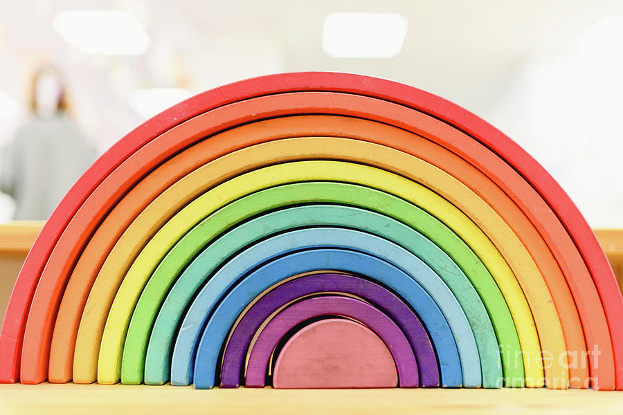 Colorful Waldorf wooden rainbow in a montessori teaching pedagogy classroom. Photograph by Joaquin Corbalan