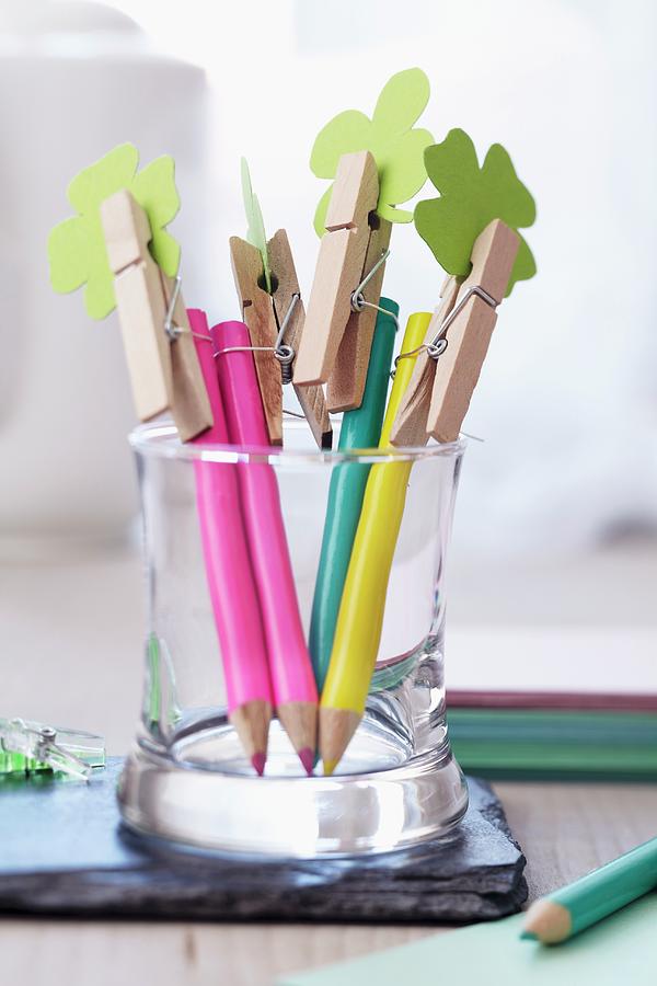 Crayon Photograph - Coloured Pencils Topped With Clothes Pegs Holding Paper Shamrock Leaves by Franziska Taube