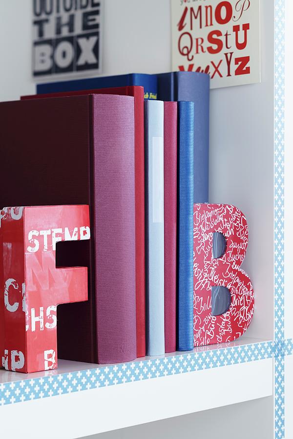 Colourful Alphabet Bookends On White Bookshelf Photograph by Franziska Taube