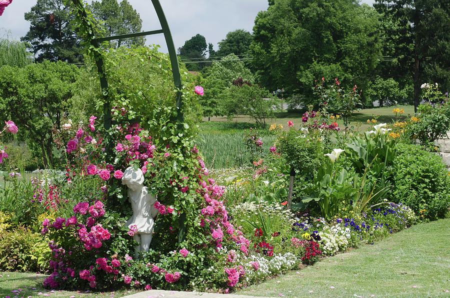 Colourful, Blooming Flower Beds In Extensive Gardens; Climbing Roses And Stone Statue In Foreground Photograph by Great Stock!