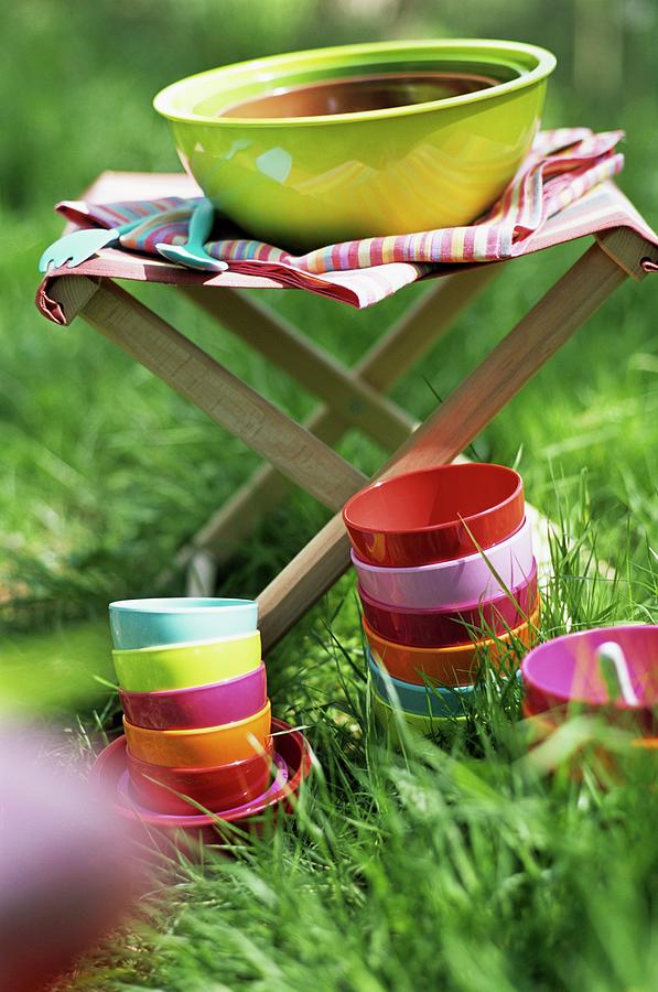 Colourful Bowls In The Grass And A Large Bowl On A Folding Stool Photograph by Frederic Vasseur