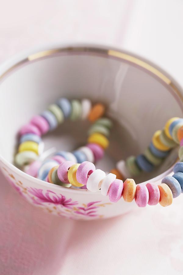 Colourful Candy Necklace In A Mug Photograph by Mandy Reschke