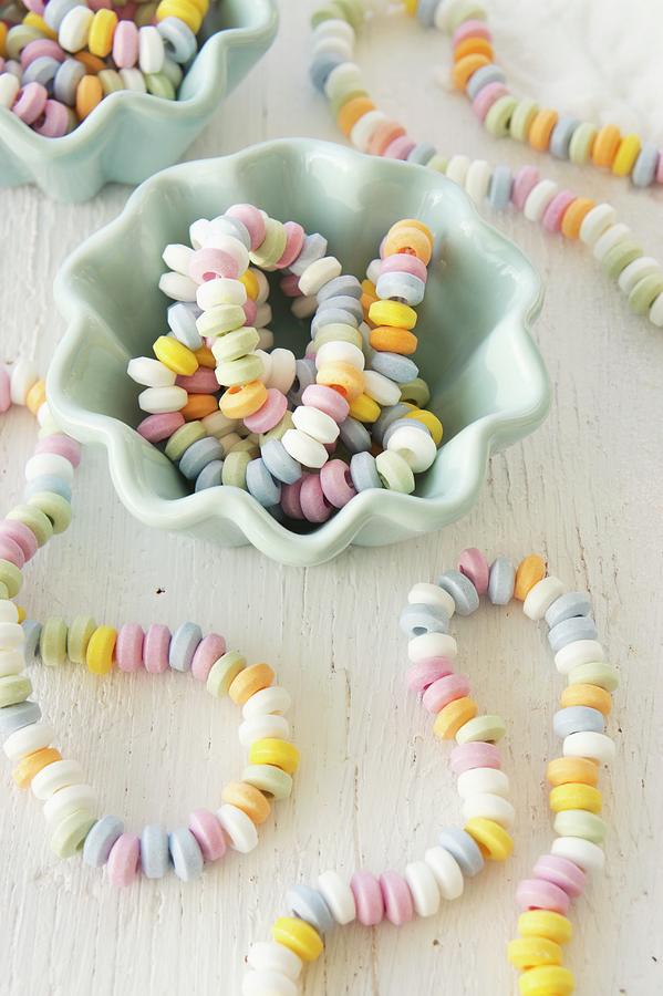 Colourful Candy Necklaces In And Next To China Bowls Photograph by Martina Schindler