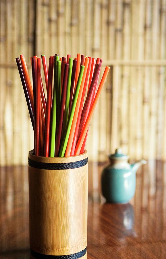 Colourful Chopsticks In A Bamboo Container On A Table In A Restaurant Photograph by Cedric Glasier Photography