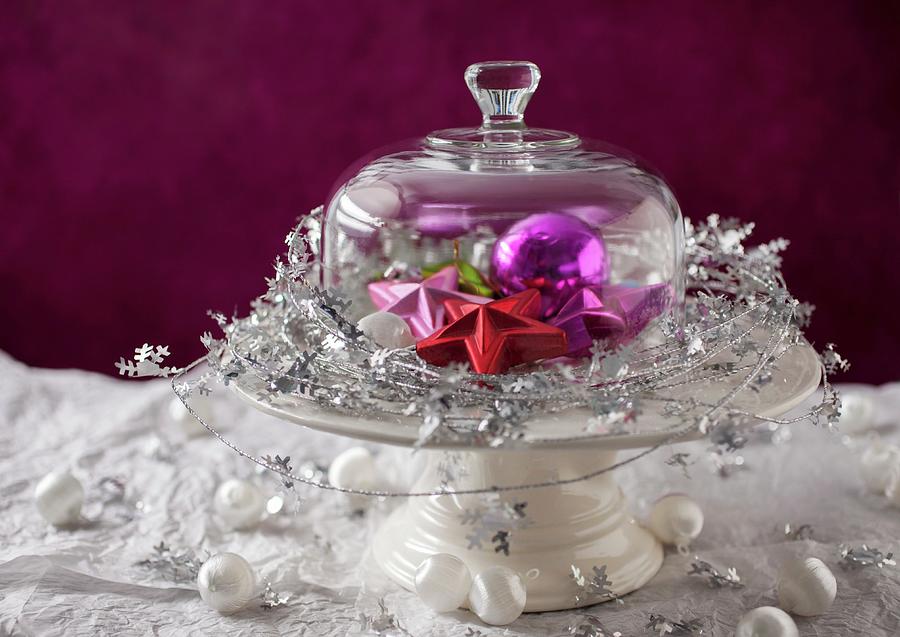 Colourful Christmas Decorations With Tree Baubles Under A Glass Cloche Photograph by Katharine Pollak