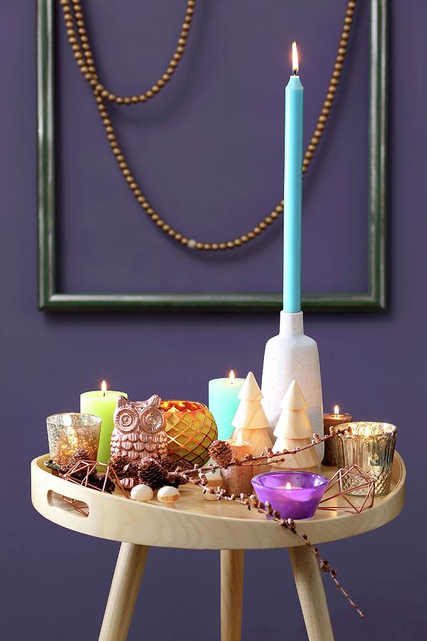 Colourful Collection Of Candles On Tray Table In Front Of Purple Wall Photograph by Thordis Rggeberg