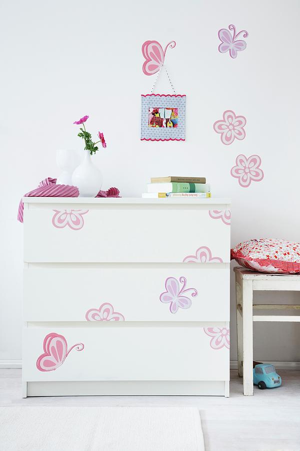Colourful Decals On Simple, White Chest Of Drawers And Wall Photograph by Franziska Taube