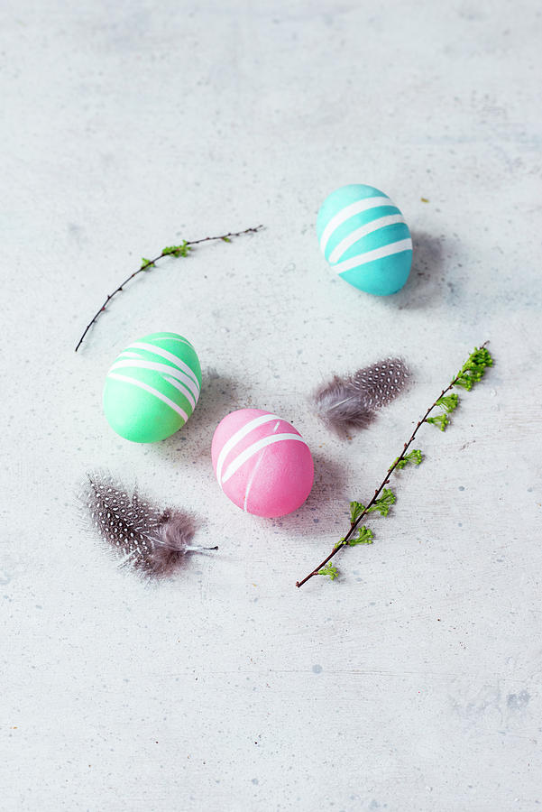 Colourful Easter Eggs, Spring Twigs And Quails Feathers Photograph by Carolin Strothe