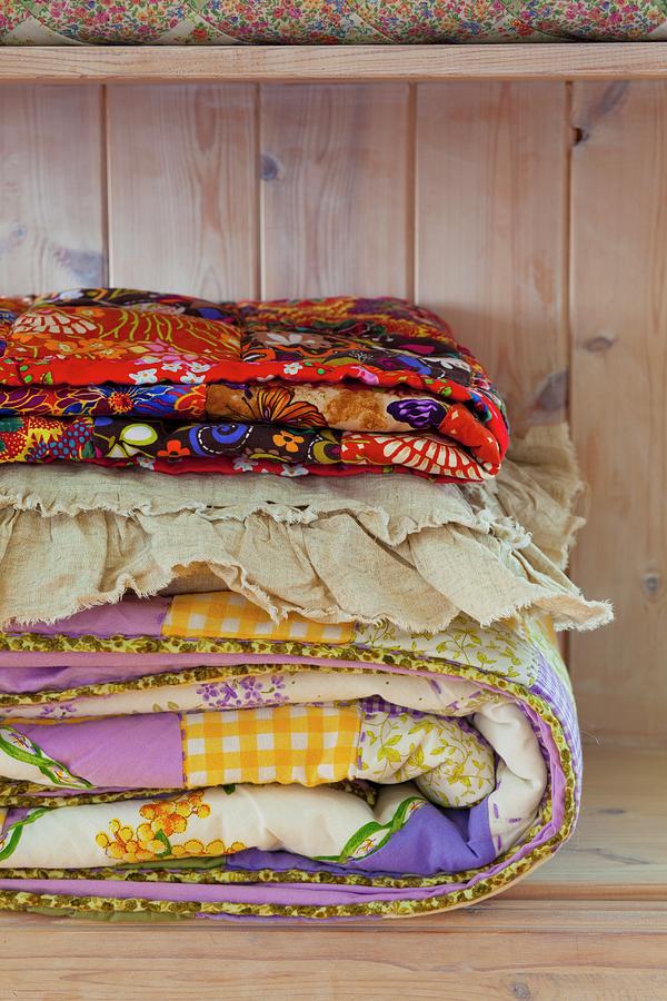 Colourful Folded Quilts In A Wooden Cupboard Photograph by Studio Lipov