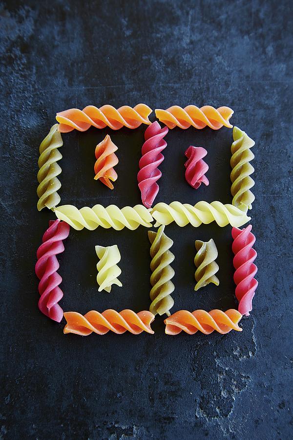 Colourful Fusilli Arranged To Form A Square Pattern Photograph by Rafael Pranschke