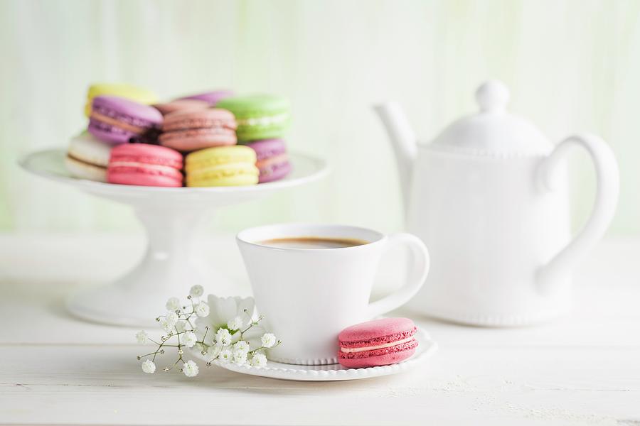 Colourful Macaroons With Coffee On A White Table Photograph by Shaiith