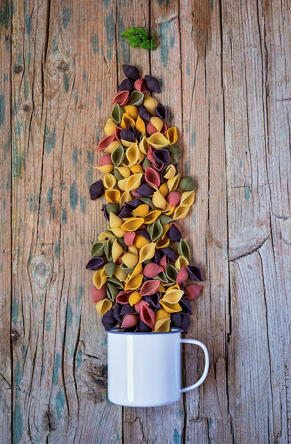 Colourful Pasta With An Enamel Mug On A Wooden Table Photograph by Eduardo Lopez Coronado
