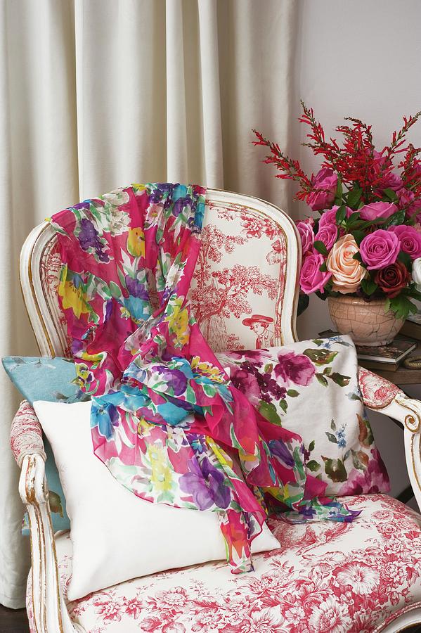 Colourful Scarf On Rococo-style Armchair Next To Flower Arrangement Photograph by Linda Burgess