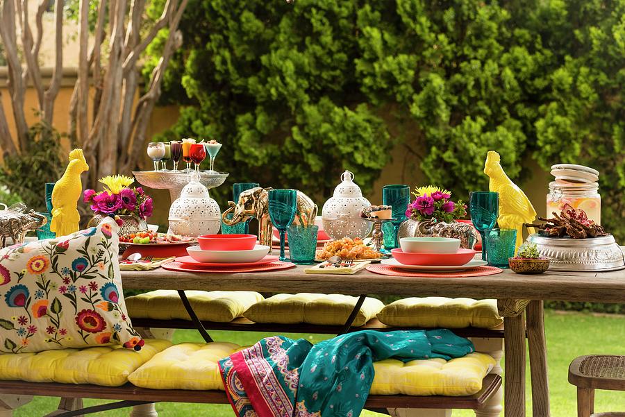 Colourful, Set Table With Lanterns, Animal Figurines, Yellow Seat Cushions On Bench And Ethnic Scatter Cushions Photograph by Great Stock!