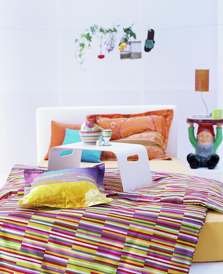 Colourful Textiles In Bedroom With Garden-gnome Bedside Table Photograph by Matteo Manduzio