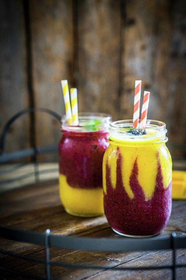 Colourful Two Layer Mango And Berry Smoothies Garnished With Blackberries Photograph by Alena Haurylik