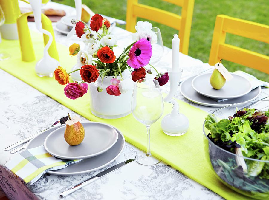Colourful Vase Of Ranunculus On Festively Set Garden Table Photograph by Great Stock!