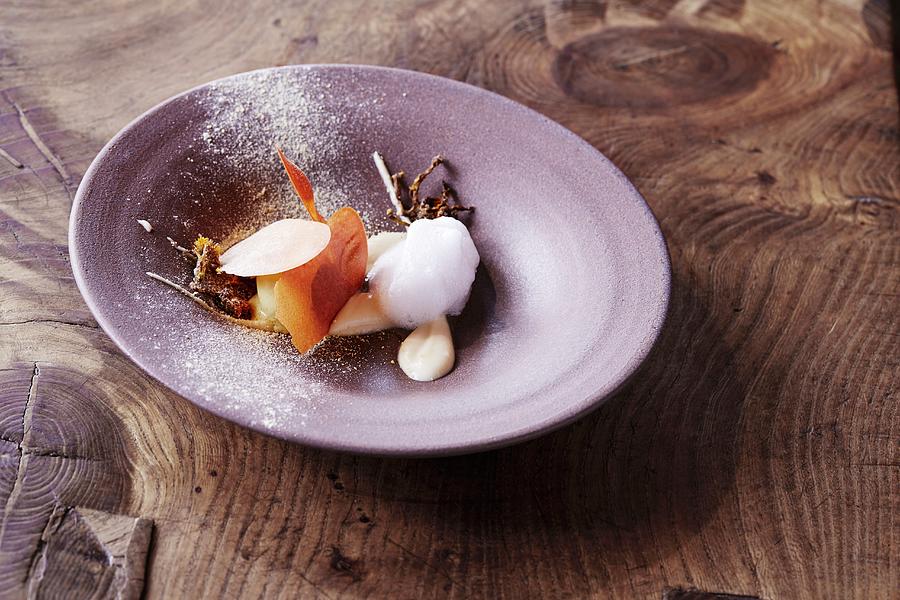 Coltsfoot Ice Cream With Parsnip And Vinegar Aged In An Oak Barrel Served At The oaxen Krog Restaurant In Stockholm Photograph by Jalag / Sren Gammelmark