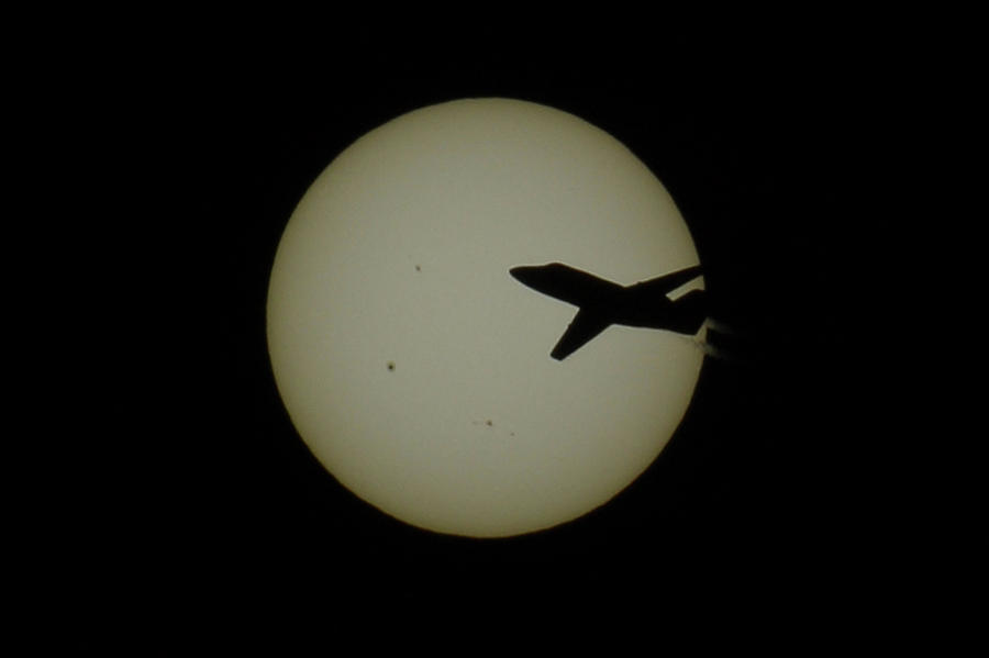 Commuter Jet and Sunspots Photograph by Shoeless Wonder