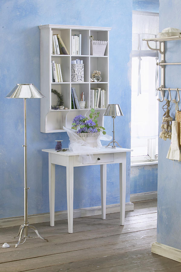Console Table Below Shelves Mounted On Pale Blue Wall Photograph by Werner Krauss